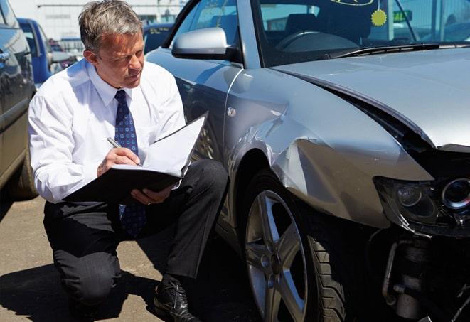 car accident scene with insurance paperwork